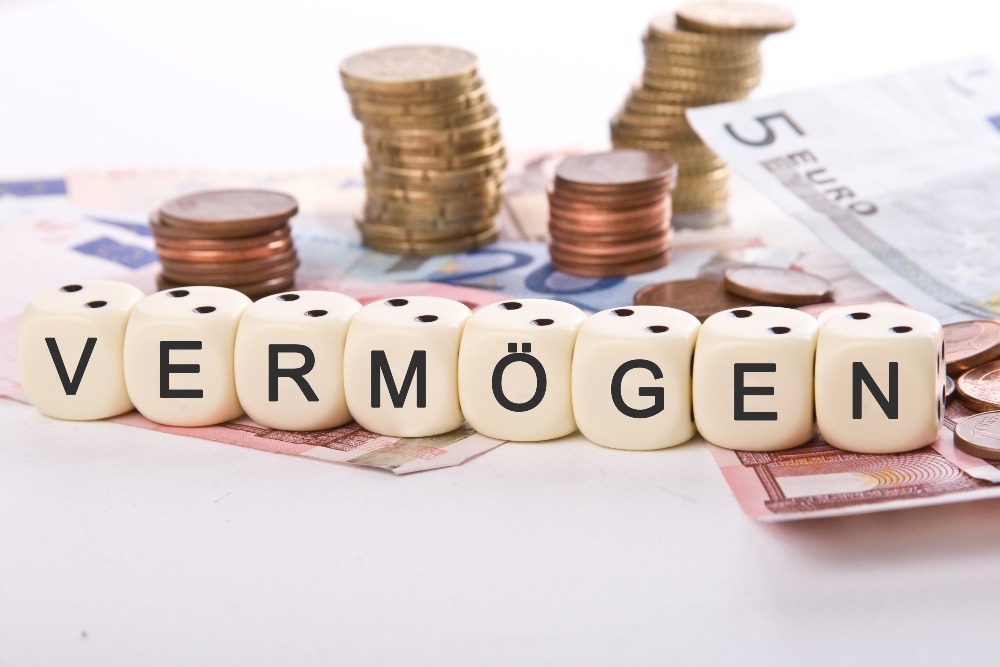 Um als Kaufmann zu gelten, bedarf es verschiedener Voraussetzungen, so spielt z.B. das Vermögen eine Rolle Geld und Würfel mit dem Wort "Vermögen"
